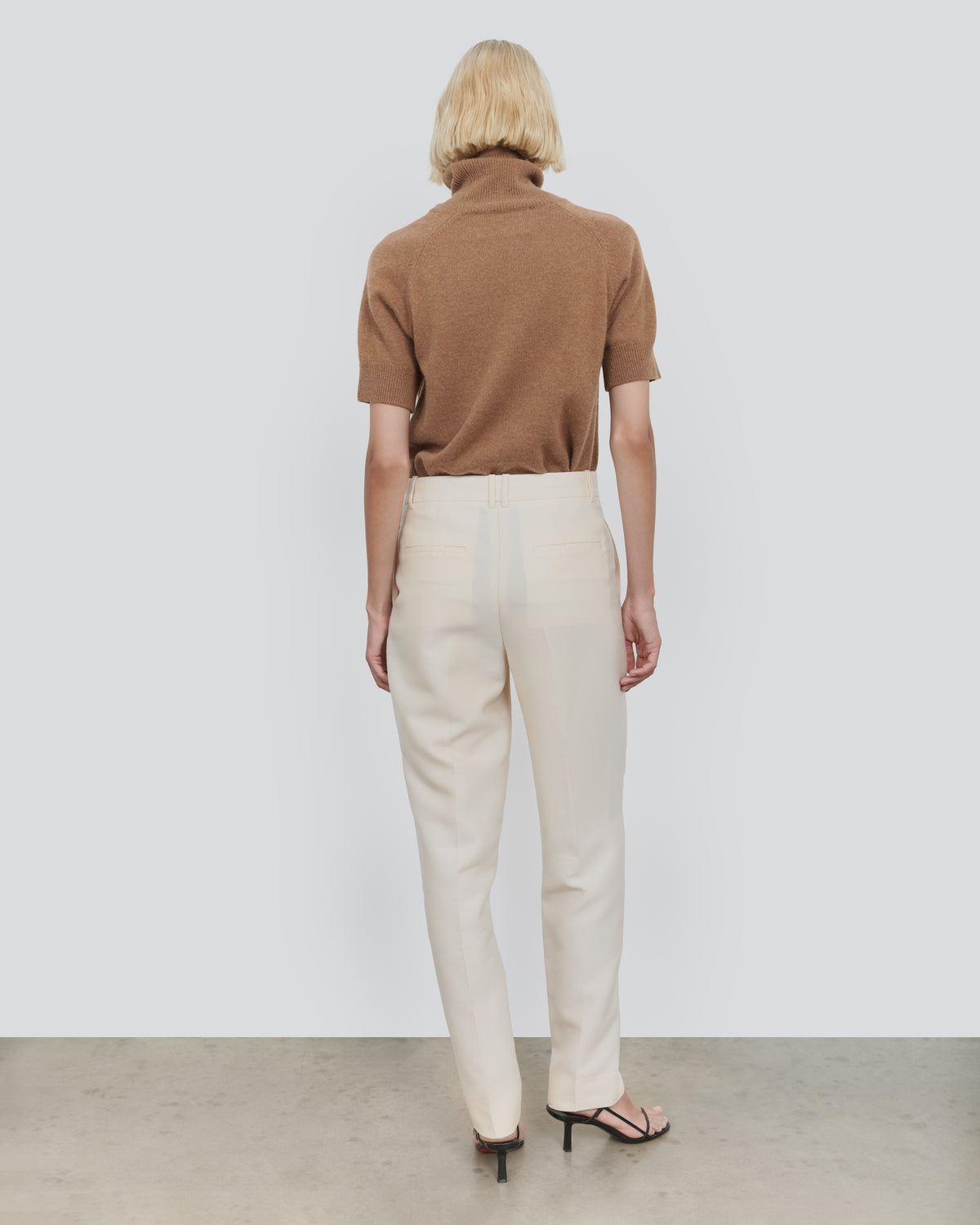 ESSENTIAL WOOL SHORT SLEEVE TURTLENECK in Camel - back view #colour_Camel