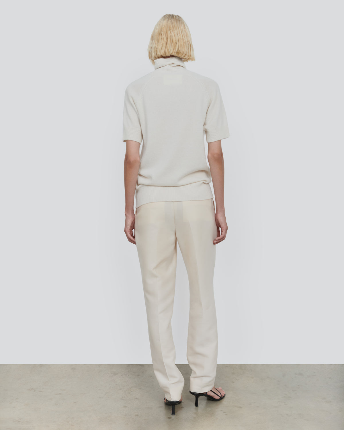 ESSENTIAL WOOL SHORT SLEEVE TURTLENECK in Ecru - back view #colour_Ecru