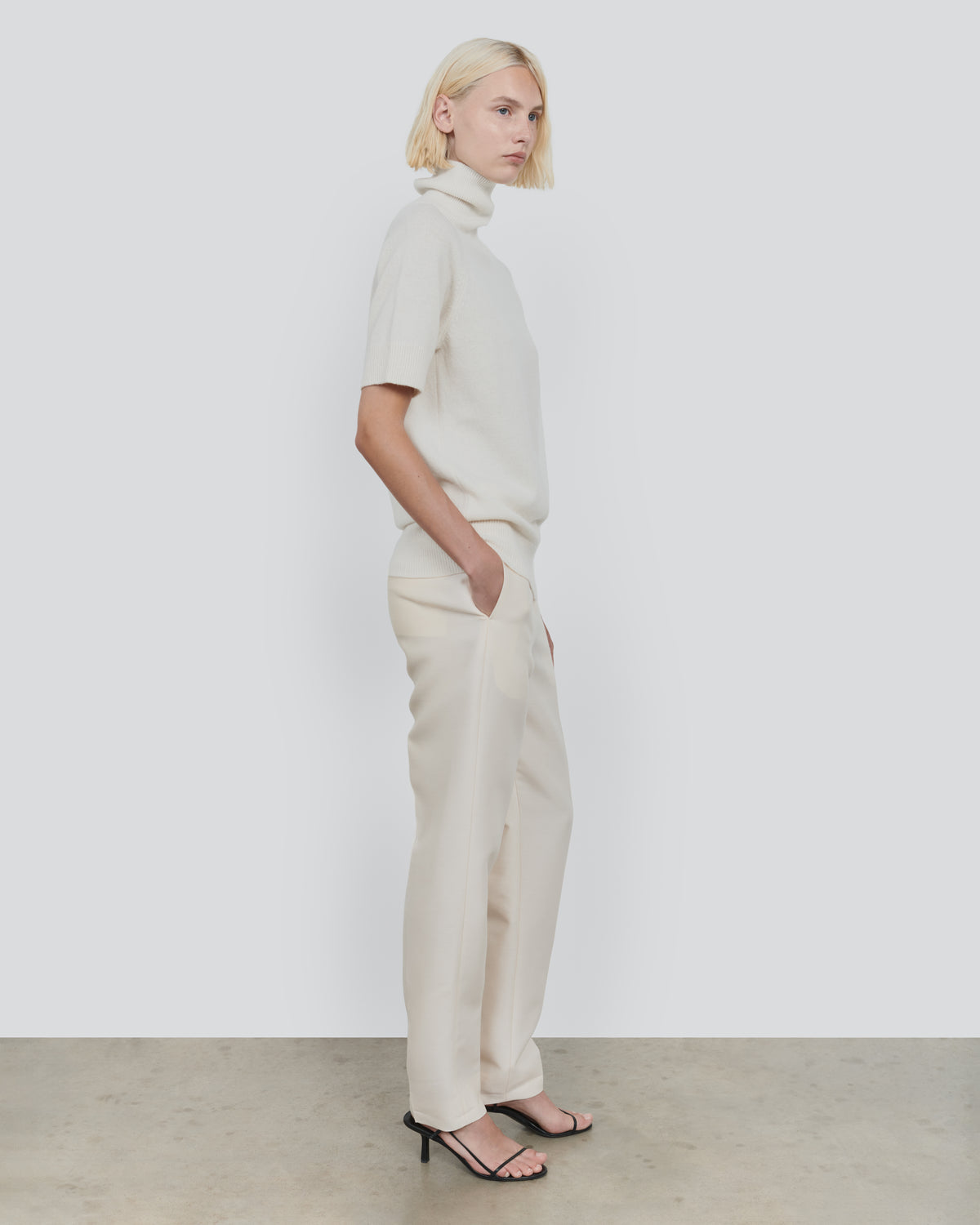 ESSENTIAL WOOL SHORT SLEEVE TURTLENECK in Ecru - side view #colour_Ecru