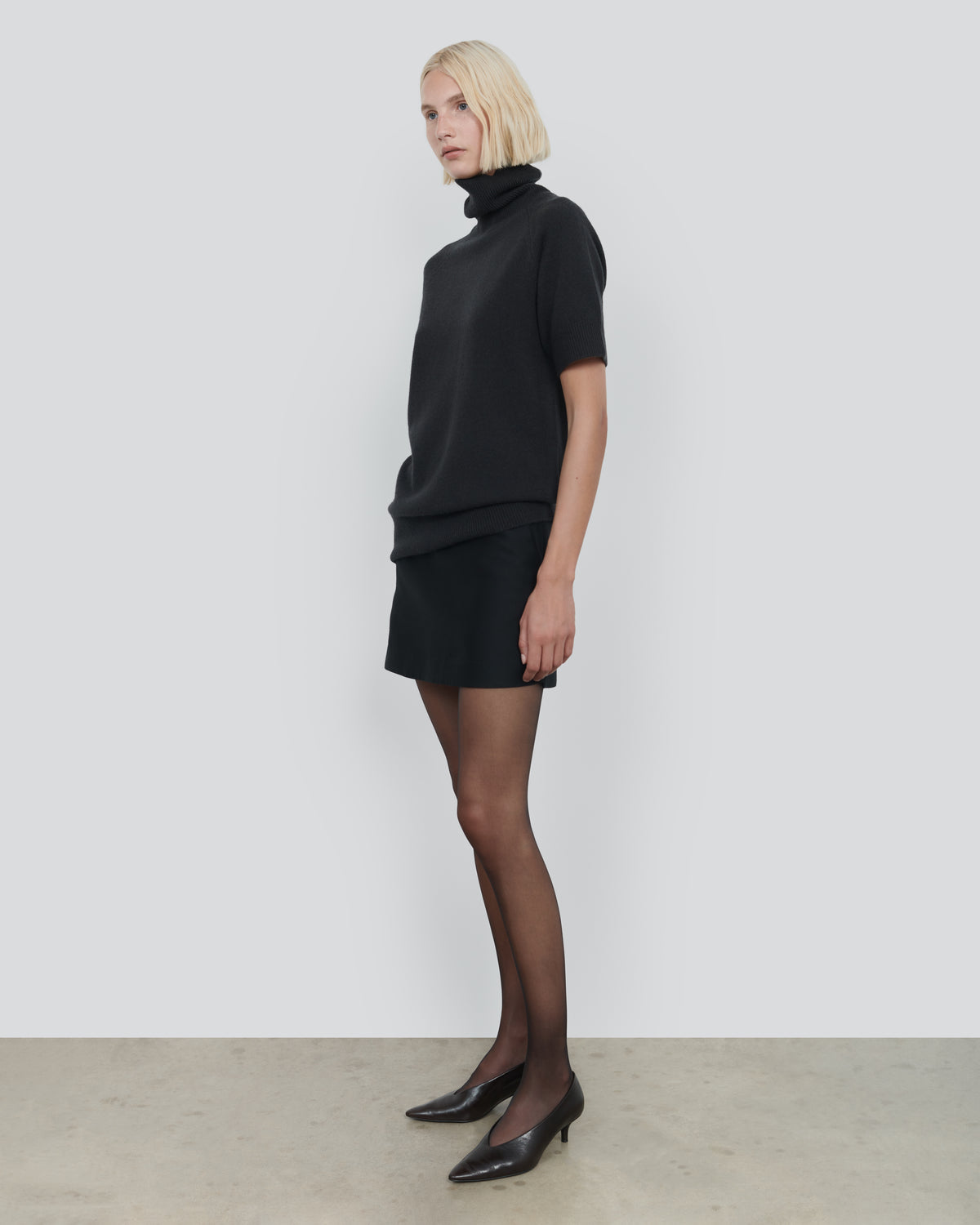 ESSENTIAL WOOL SHORT SLEEVE TURTLENECK in Dark Grey - side view #colour_Dark Grey